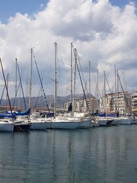 Sailboats moored in harbor