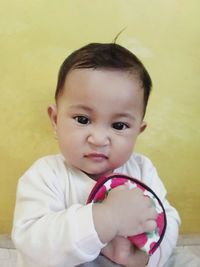 Portrait of cute boy against wall