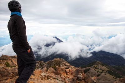 Man standing on mountain against sky