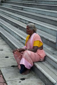 Senior woman sitting on steps