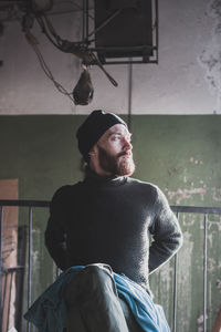 Portrait of man wearing hat looking away