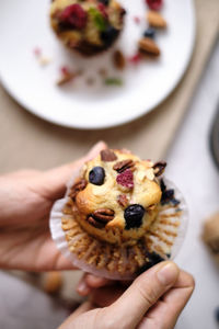 Midsection of person holding cake