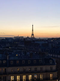 Buildings in city at sunset