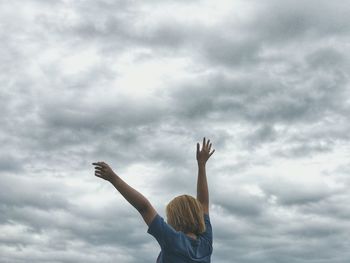 Low angle view of woman against sky