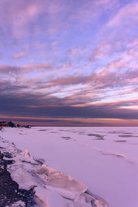 Scenic view of frozen sea against sky during sunset