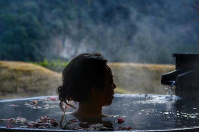 Portrait of woman in a hot tub