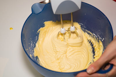 Midsection of person preparing food in bowl