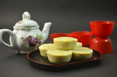 Close-up of tea cup on table against black background