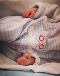 Midsection of baby girl on bed