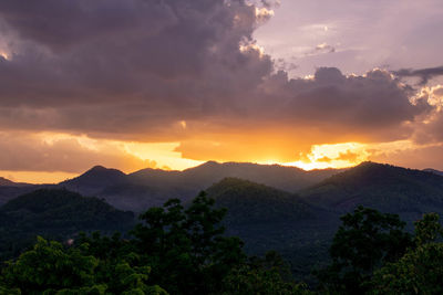 Scenic view of silhouette mountains against sky at sunset