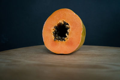 Close-up of orange papaya fruit on table