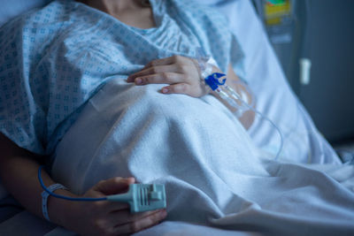 Pregnant woman on a delivery room relaxing on bed