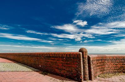 Retaining wall against blue sky during sunny day