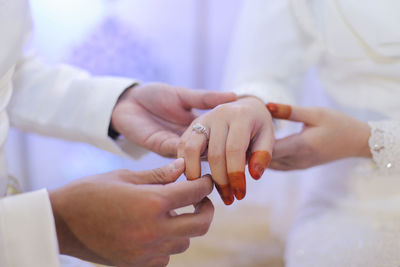 Close-up of couple holding hands