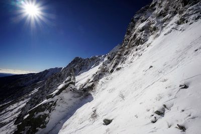 Scenic view of snow covered mountains against clear sky