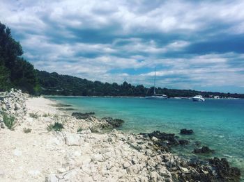 Scenic view of sea against cloudy sky