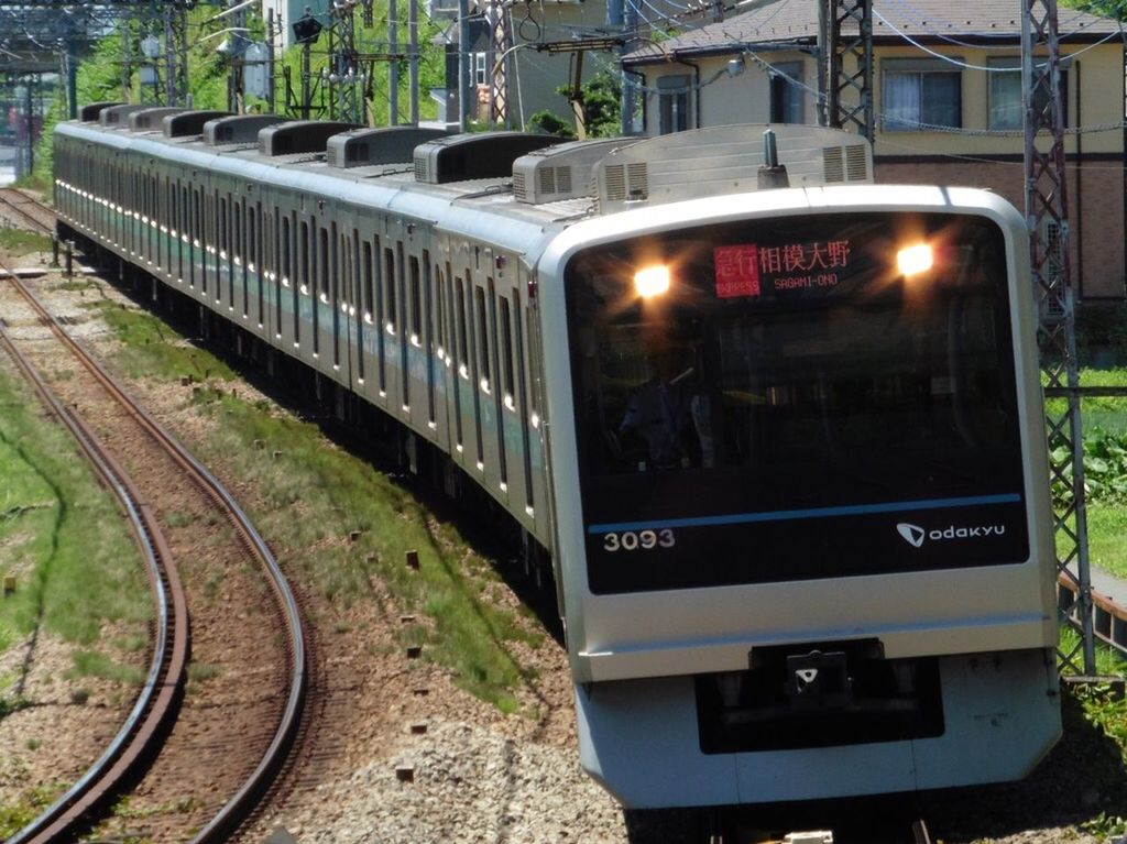 transportation, mode of transport, building exterior, architecture, built structure, land vehicle, public transportation, railroad track, text, rail transportation, communication, city, railroad station, illuminated, train - vehicle, car, information sign, western script, travel, tree