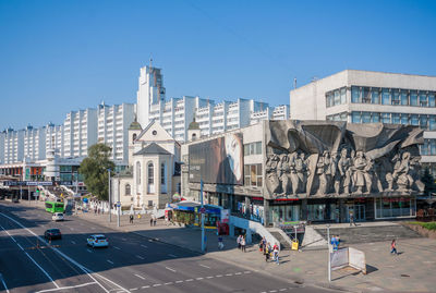 Vehicles on road against buildings in city