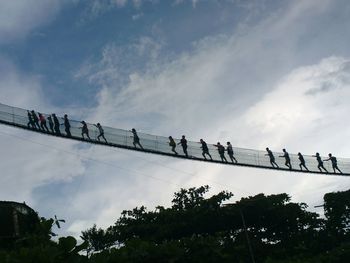 Low angle view of people against sky