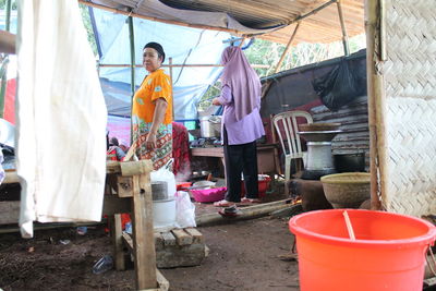 People working at market stall