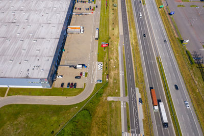 Aerial top view of the large logistics park with warehouse, loading hub with many semi-trailers .