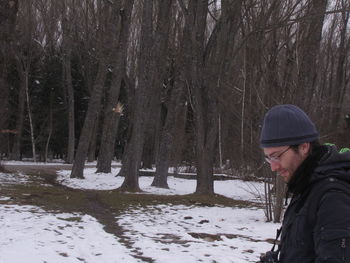 Side view of man in forest during winter