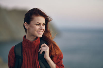 Portrait of smiling young woman standing outdoors