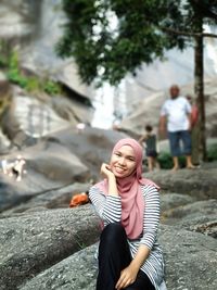 Woman sitting on rock