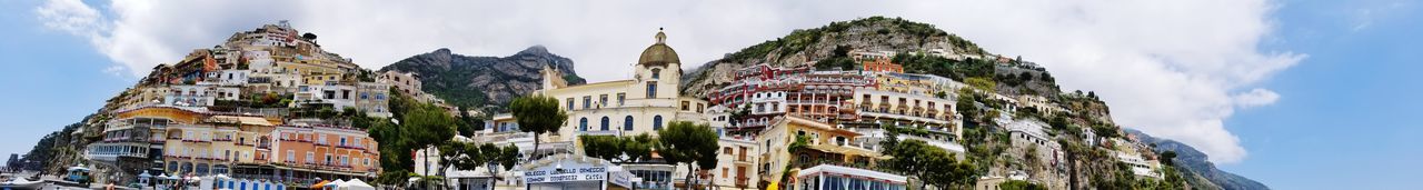 Low angle view of buildings against cloudy sky