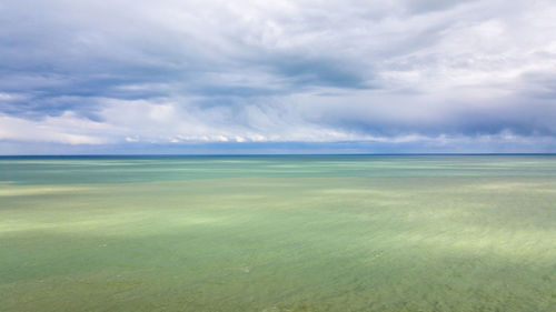 Scenic view of sea against cloudy sky