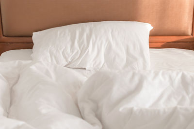 Close-up of white blanket on bed at home