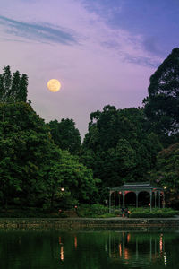 Scenic view of lake against sky at night