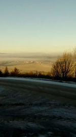 Snow covered landscape against sky