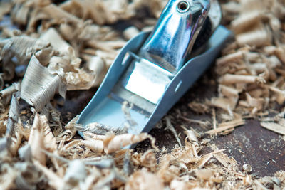 Close-up of spokeshave with saw curls.