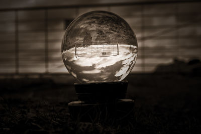 Close-up of wineglass on field against sky