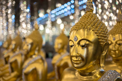 Close-up of statue against illuminated temple