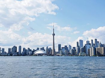 View of buildings in city against cloudy sky