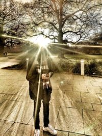 Men holding umbrella against sun