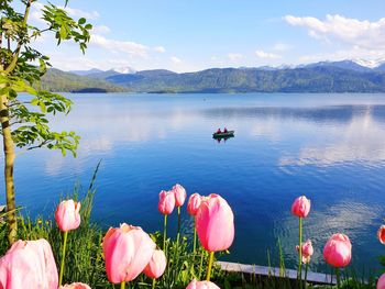 Scenic view of lake by mountain against sky