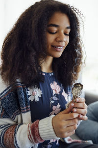 Portrait of smiling young woman having drink