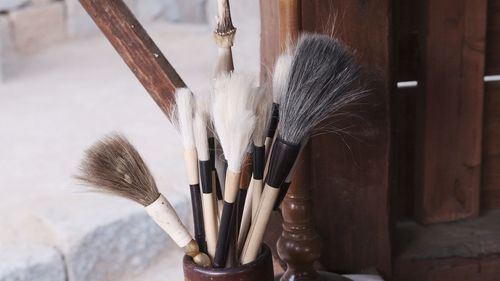 Close-up of paintbrushes on wood