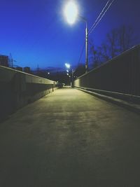 Empty road against sky in city at night