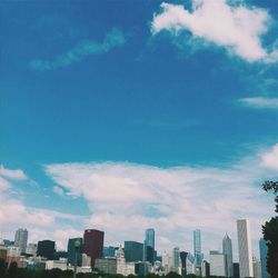 Low angle view of buildings against cloudy sky
