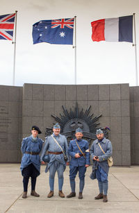 People standing in front of flags