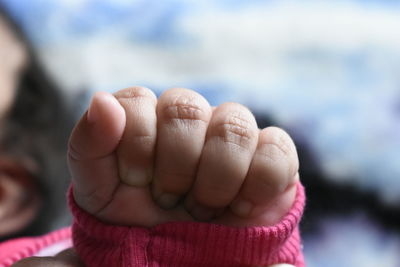 Close-up of baby with clenching fist
