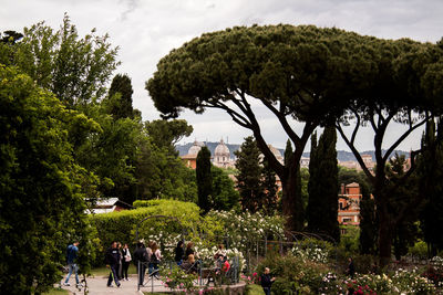 Group of people in park against buildings