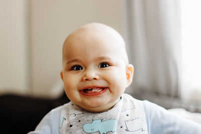 Portrait of cute baby sitting at home