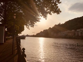 Scenic view of river against sky at sunset