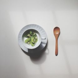 High angle view of vegetables in bowl against white background