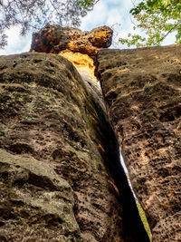 Low angle view of rock formation against sky